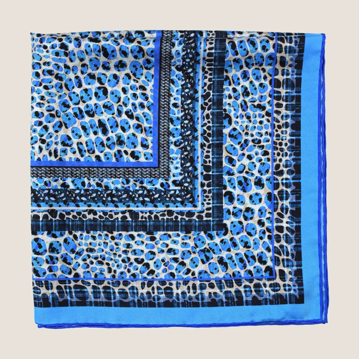 The Tiger Cobalt silk square, folded and shown flat
