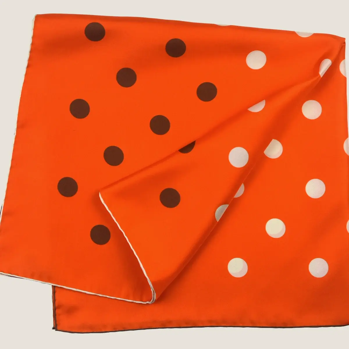 The Solitaire Spot Orange Cafe silk square, folded and shown flat