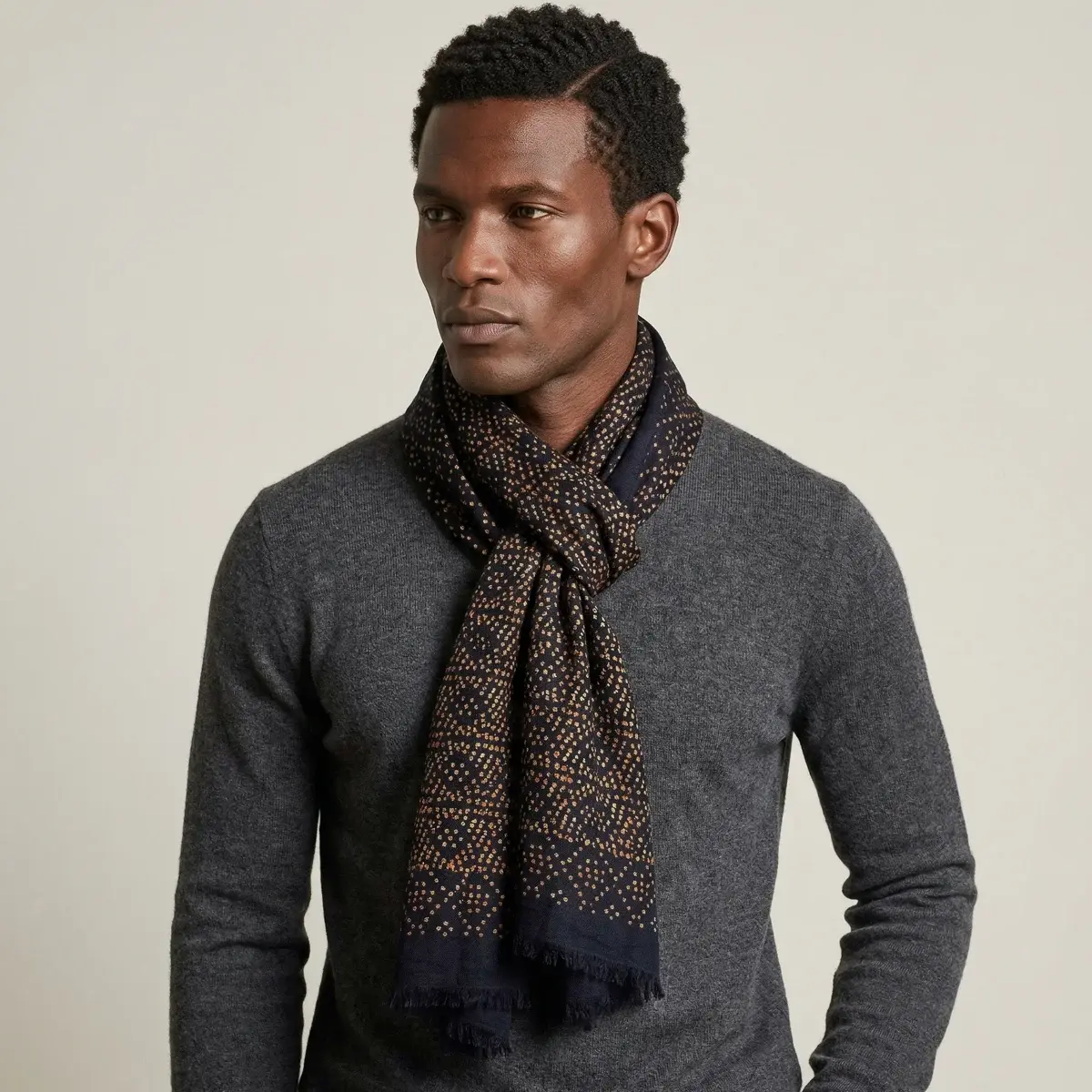 The Starry Midnight Laslett Wrap worn at the neck over a grey sweater