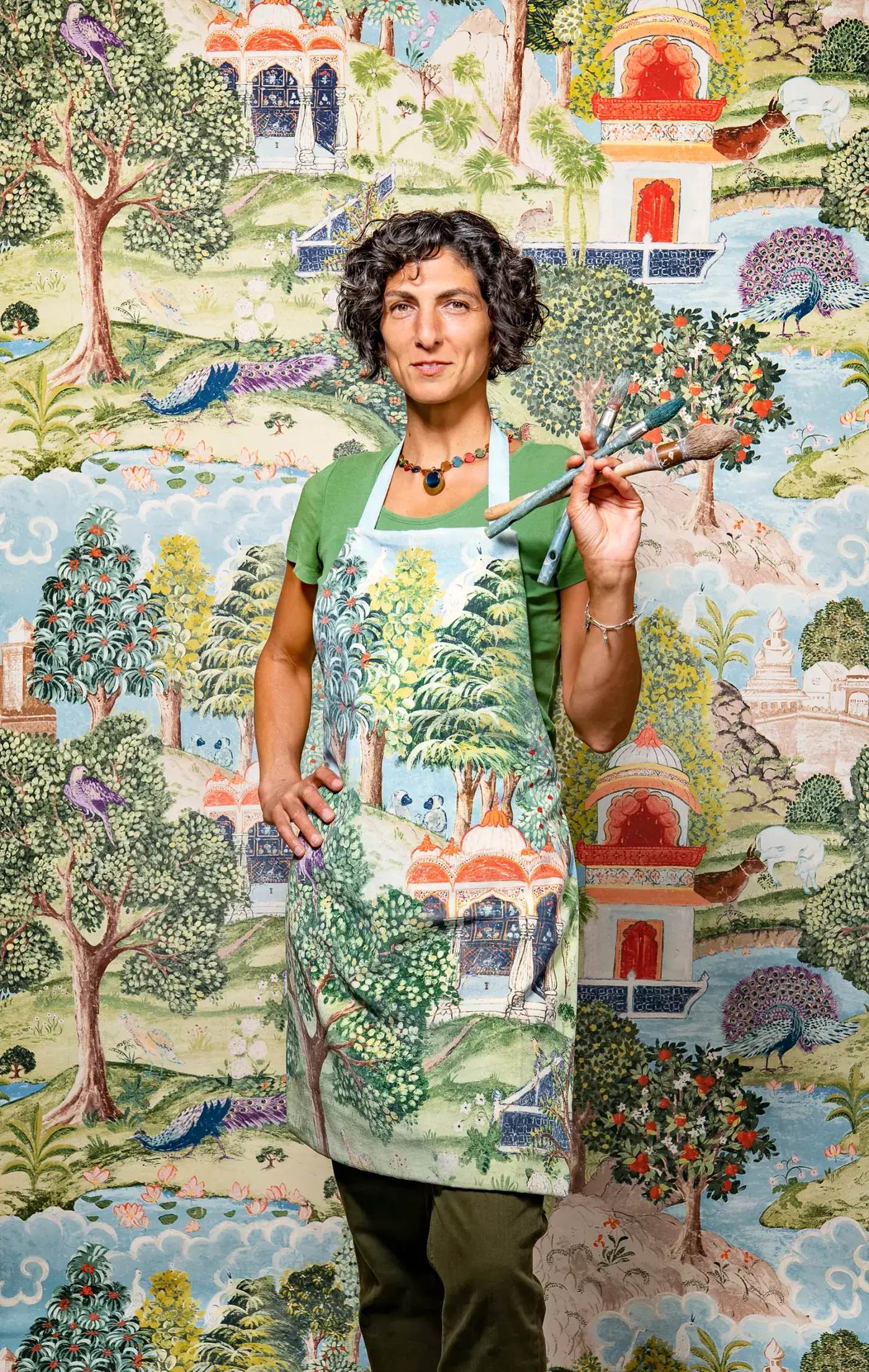 Melissa White in her Hastings studio, in front of one of her hand painted papers